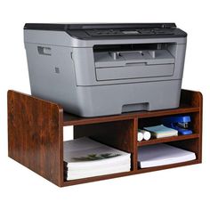 a printer sitting on top of a wooden shelf