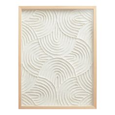 a white wall hanging on the side of a wooden framed art piece with wavy lines