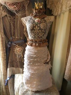 a dress made out of lace with a crown on top