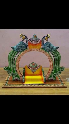 an elaborately decorated stand with two peacocks on it