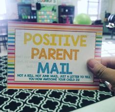 a person holding up a card that says positive parent mati not a bill, not a mail, just a letter to tell you how awesome your child is