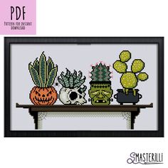 a cross stitch pattern with cactuses and cacti on a table in front of a