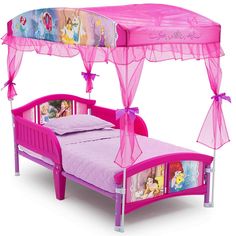 a pink princess bed with canopy and mosquito netting over it's head, in front of a white background