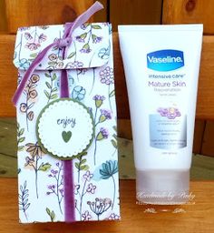 a tube of cream next to a gift bag