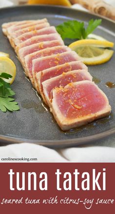 tuna tataki served with citrus - yogurt sauce on a black platter