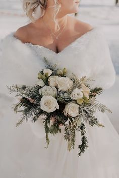 a woman in a wedding dress holding a bouquet