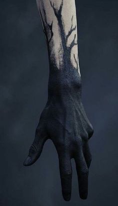 a person's hand with a tree painted on the arm and wrist, against a dark background