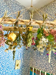 flowers hanging from the ceiling in a blue and white room