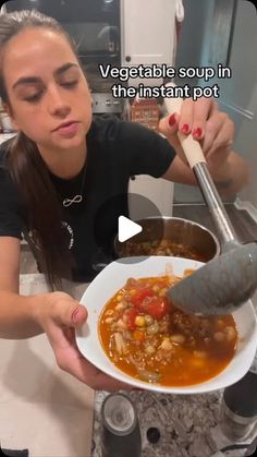 a woman holding a bowl of soup with a ladle in her hand and the caption reads vegetable soup in the instant pot