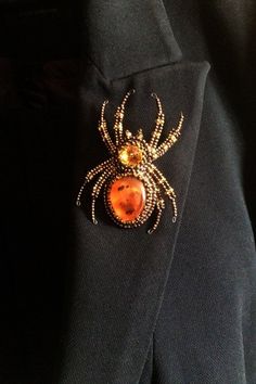 "Buy the Spider jewelry as unique Halloween brooch. Spider pin has a has a size approximately 2*3 inches (5*7,5 cm). This Beaded insect brooch is the best Halloween gift. A Spider jewelry brooch is carefully bead embroidered on leather using Czech crystals, seed beads. The central element can be made of imitation of amber, other gemstone or crystal to your order. * Size gold insect brooch: approx. 2*3 inches (5*7,5 cm) with a sweep of all his paws * Color customization for custom orders is avail Handmade Brooches For Halloween Gift, Halloween Brooch Jewelry Gift, Halloween Gift Jewelry Brooch, Halloween Accessories Jewelry, Bugs Embroidery, Spider Brooch, Spider Crafts, Insect Brooch, Spider Jewelry