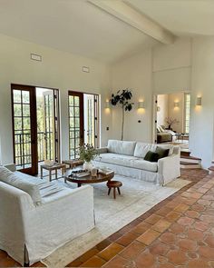 a living room filled with furniture and windows