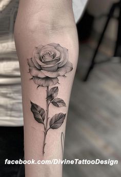 a black and white rose tattoo on the leg