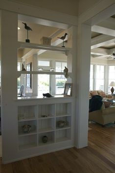 a living room filled with furniture and lots of windows