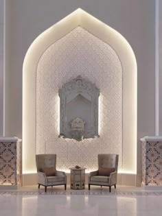 two chairs sitting in front of a white wall with a mirror on it's side