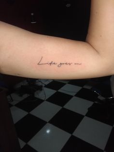 a woman's arm with the words love you written on it, in cursive font