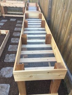 an outdoor garden area with steps made out of wood