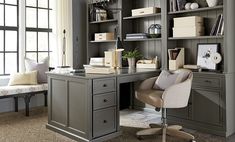 a home office with gray walls and furniture