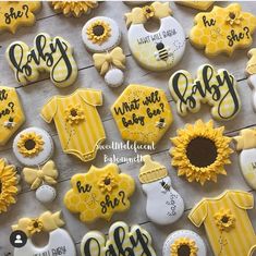 baby shower cookies decorated with yellow and white icing, sunflowers and ones