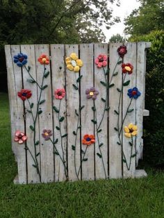 a wooden fence with flowers painted on it