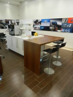 a kitchen with wooden floors and white cabinets