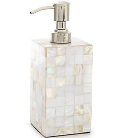 a soap dispenser made out of mother of pearl tiles on a white background