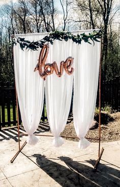 two white drapes with the word love on them