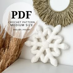 two white snowflakes are next to each other on a shelf with the text, crochet pattern medium size english / polish