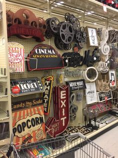 there are many signs on the wall in this store that is filled with different items