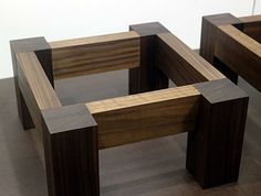 two wooden benches sitting on top of a hard wood floor