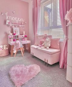 a room with pink furniture and curtains in it