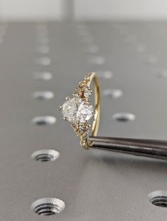 a diamond ring sitting on top of a metal surface