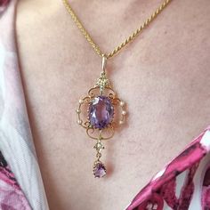 This fantastic antique piece features an elegant pendant set with an oval amethyst and a pear shaped amethyst drop, the outer frame and halter set with seed pearls, complete with a matching rope chain, all crafted in 15ct yellow gold. Circa 1900-1910. Stamped "15C" to the back of the pendant. The pendant measures approximately 50.7mm (H) x 20.8mm (W). The length of the chain measures approximately 40cm. The approximate total weight is 7.8 grams. Please note that the antique box pictured is for d Antique Pear-shaped Gemstone Jewelry, Elegant Lavender Hallmarked Jewelry, Purple Pear-shaped Elegant Jewelry, Elegant Purple Pear Shaped Jewelry, Elegant Purple Teardrop Pendant Jewelry, Elegant Purple Oval Pendant Necklace, Elegant Purple Filigree Necklace, Elegant Purple Pear-shaped Necklace, Elegant Lavender Teardrop Necklace