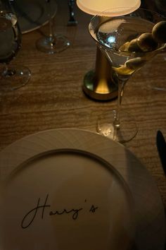 there is a plate with an inscription on it next to a wine glass and knife