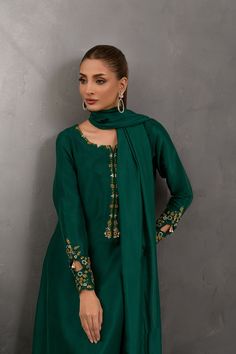 SKU: 1025 Price for Shirt and inner only.Amongst the deepest shade of green this stunning creation is crafted using the finest raw silk adorned with beautiful French knots work further garnished with lovely pearls and sequins. Paired with a same-toned dupatta to complete the look. Green Chinon Sharara For Party Wear, Elegant Green Festive Sharara, Elegant Green Sharara With Dabka, Elegant Green Sharara With Dabka Detailing, Green Raw Silk Sets For Party, Green Embellished Unstitched Salwar Kameez, Elegant Green Salwar Kameez With Mirror Work, Elegant Green Chinon Kurta, Elegant Green Kurta With Mirror Work