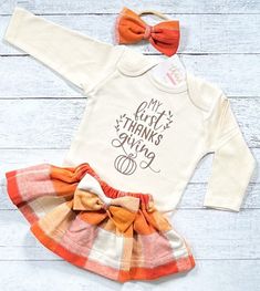 "My First Thanksgiving Outfit, Baby Girl Thanksgiving Dress, Thanksgiving Shirt, Niece Aunt Gift You may choose: ~\"My First Thanksgiving\" bodysuit as shown. Available in short or long sleeve. ~Gorgeous plaid skirt created with very soft flannel fabric. ~Matching fabric bow/headband All items are handmade in our studio with loving care. Christi Creations - creating happy moments one tutu at a time Check out other items in our shop! http://www.christicreations.etsy.com Copyright © 2008 by Christ Thanksgiving Outfit Baby, My First Thanksgiving, Thanksgiving Baby Outfits, Girls Thanksgiving Outfit, Thanksgiving Dress, Fabric Matching, Girls Thanksgiving