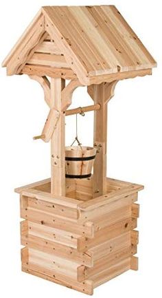 a wooden structure with a bell on the top and a bucket in the bottom that is filled with water