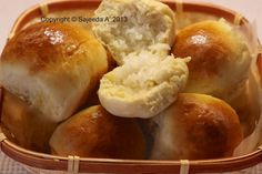 a basket filled with rolls covered in butter