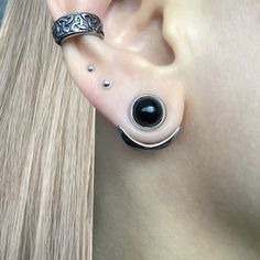 an ear with two black stones on it