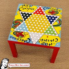 a colorful table with an image of a star and dragon painted on it's side