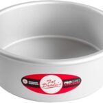 a white cake pan with red and black labels on the bottom, sitting in front of a white background