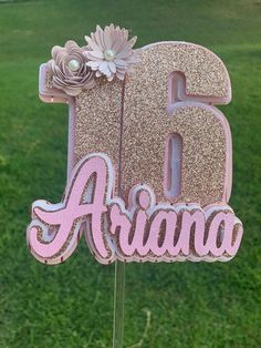 a pink and gold glitter birthday cake topper