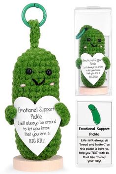 a crocheted keychain with a cute green pickle holding a heart