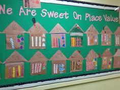 a bulletin board that has been decorated with numbers and candles on it for the school's sweet on place value