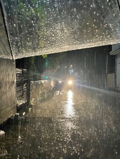 a car driving down a rain soaked street at night