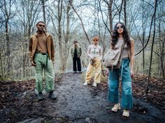 three people are walking in the woods together