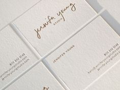 four business cards with gold ink on them and the word jenny written in cursive writing