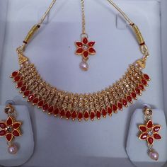 Step into the realm of timeless elegance with our Antique Gold Polki Choker, adorned with exquisite jhumkas and tikka, a stunning piece of Indian jewelry that exudes regal charm and sophistication. Crafted with meticulous attention to detail, this choker necklace features intricate antique gold polki work, reminiscent of traditional craftsmanship. The addition of jhumkas and tikka adds an extra layer of grace and beauty, making it a perfect choice for brides or anyone seeking to make a statement Red Jewelry With Latkans For Eid, Heavy Tikka As Gift For Navratri, Red Temple Jewelry For Eid, Red Kundan Necklace With Latkans For Ceremonial Occasions, Heavy Tikka Gift For Navratri, Heavy Tikka For Navratri Gift, Red Jewelry Sets For Ceremonial Occasions Like Diwali, Red Jewelry For Eid Celebration, Red Jewelry With Stone Work For Eid