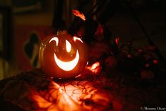 an illuminated pumpkin sitting on top of a table