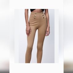 Elevate Your Wardrobe With These Modern Zara Leggings In A Beautiful Tan Color. These Leggings Feature A High-Rise Waistline, Making Them Perfect For Any Occasion. The Gold Button Accents Add A Touch Of Elegance To The Overall Design, Making Them A Versatile Addition To Any Wardrobe. Made From A Blend Of Polyester, Spandex, And Viscose, These Leggings Are Both Comfortable And Durable. They Are Perfect For Women Of All Sizes, With A Regular Fit And Ankle Style. Made In Cambodia, These Leggings Ar Zara Leggings With Gold Buttons, Black Slim Fit Pants, Bell Bottom Leggings, Ripped Leggings, Coated Leggings, Zara Leggings, Zipper Leggings, Faux Leather Pencil Skirt, Brown Leggings