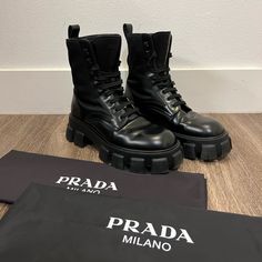 Prada Monolith Leather And Re Nylon Boots. Highly Sought After Prada Combat Boots. 10000% Authentic With All Details Pictured. Marked Size 9. Excellent Used Condition With Some Creasing In Leather And Light Scuffs Around Lugs And On Soles. Please See Photos Carefully. Comes With Original Dust Bags. Does Not Come With Pouches. Fast Shipping!! Thanks For Viewing Keywords: Loafer, Derby, Dress Shoes, Platform, Chunky, Black Luxury Streetwear Boots With Round Toe, Luxury Calf Leather Combat Boots With Round Toe, Designer Waterproof Boots With Round Toe, Designer Winter Boots With Lug Sole, Designer Black Boots With Vibram Sole, Luxury Black Boots With Vibram Sole, Luxury Black Calf Leather Combat Boots, Vintage Prada Sport Boots, Prada Leather Boots